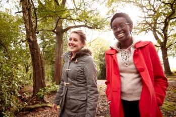 2 students walking in the woods